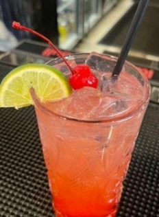 Cocktail with a lime and cherry garnish
